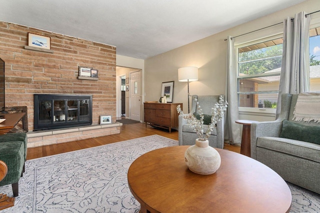 923 Par 4 Rd, Kalamazoo, MI 49008 - living area featuring wood finished floors and a brick fireplace