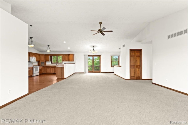 6893 Sanford Rd, Howell, MI 48855 - unfurnished living room with dark colored carpet, a ceiling fan, and lofted ceiling