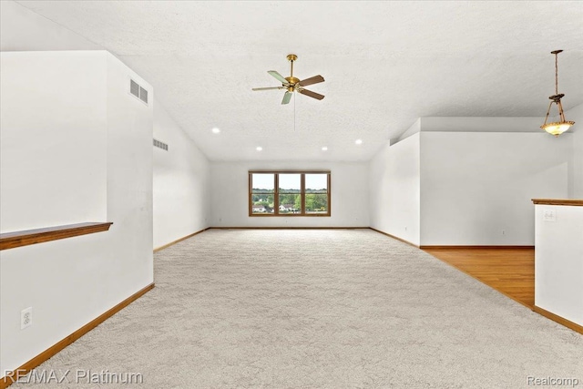 6893 Sanford Rd, Howell, MI 48855 - carpeted spare room featuring ceiling fan, lofted ceiling, and a textured ceiling
