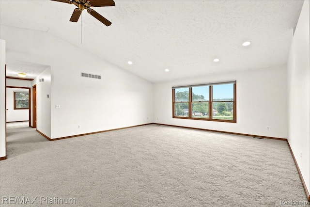 6893 Sanford Rd, Howell, MI 48855 - spare room featuring light colored carpet, vaulted ceiling, a ceiling fan, recessed lighting, and a textured ceiling
