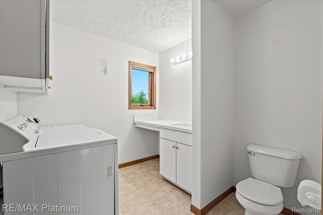 6893 Sanford Rd, Howell, MI 48855 - laundry room with washer and dryer and a textured ceiling