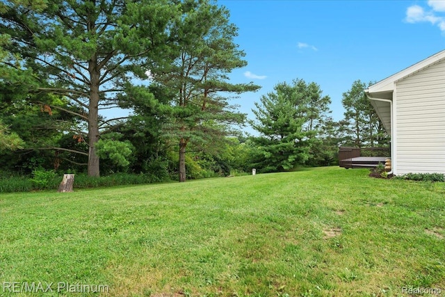 6893 Sanford Rd, Howell, MI 48855 - view of green lawn with a deck