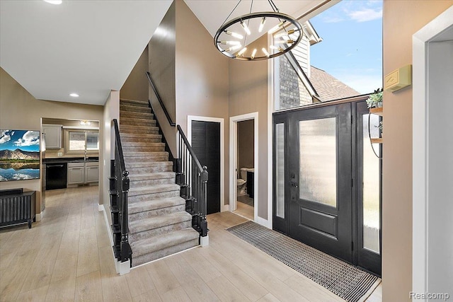 15924 Myrtle Dr, Macomb, MI 48042 - foyer with stairway, light wood finished floors, a chandelier, a high ceiling, and recessed lighting