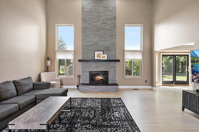 15924 Myrtle Dr, Macomb, MI 48042 - living area with a high ceiling, wood finished floors, and a fireplace