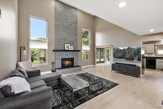 15924 Myrtle Dr, Macomb, MI 48042 - living area featuring a towering ceiling, light wood-type flooring, a stone fireplace, and recessed lighting