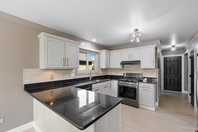 15924 Myrtle Dr, Macomb, MI 48042 - kitchen with gas stove, a peninsula, crown molding, tasteful backsplash, and dark stone counters