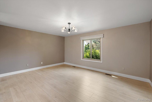 15924 Myrtle Dr, Macomb, MI 48042 - empty room with a chandelier and light wood-style floors