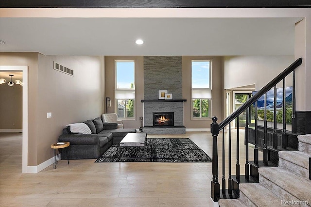15924 Myrtle Dr, Macomb, MI 48042 - living area featuring plenty of natural light, stairway, a fireplace, light wood-type flooring, and recessed lighting