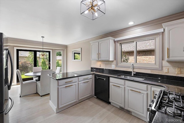 15924 Myrtle Dr, Macomb, MI 48042 - kitchen featuring black appliances, a chandelier, a peninsula, plenty of natural light, and crown molding