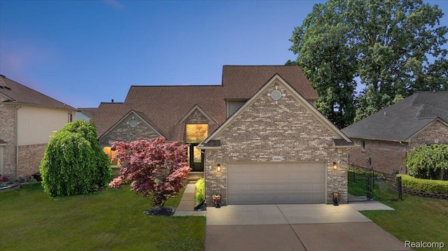 15924 Myrtle Dr, Macomb, MI 48042 - view of front of home featuring concrete driveway, an attached garage, brick siding, and a gate