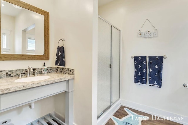 6129 W Bay Ct, Hudsonville, MI 49426 - full bath featuring a stall shower, wood finished floors, vanity, and tasteful backsplash
