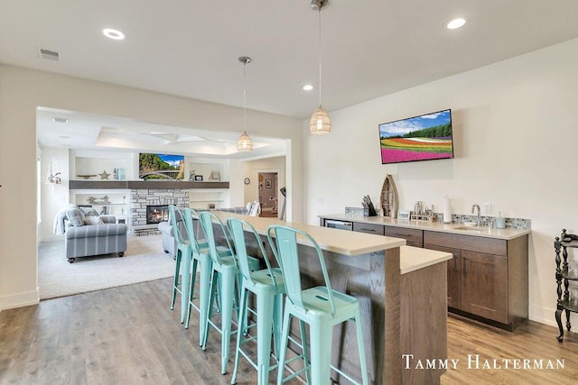 6129 W Bay Ct, Hudsonville, MI 49426 - kitchen featuring a kitchen breakfast bar, a center island, light countertops, light wood-style flooring, and recessed lighting