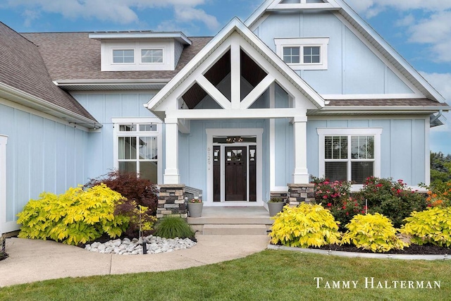 6129 W Bay Ct, Hudsonville, MI 49426 - doorway to property with board and batten siding and a shingled roof