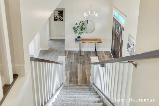 6129 W Bay Ct, Hudsonville, MI 49426 - stairway with wood finished floors and a chandelier