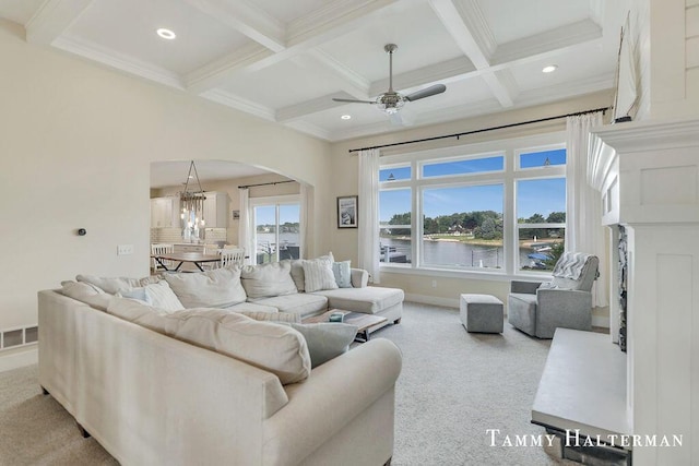 6129 W Bay Ct, Hudsonville, MI 49426 - carpeted living room featuring arched walkways, coffered ceiling, beam ceiling, a ceiling fan, and a fireplace with raised hearth