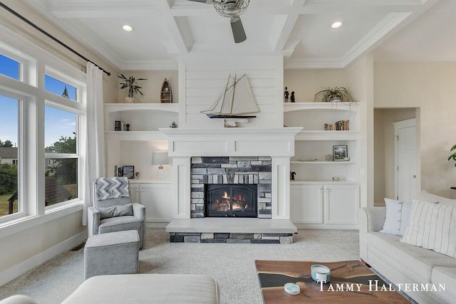 6129 W Bay Ct, Hudsonville, MI 49426 - carpeted living area featuring a ceiling fan, crown molding, a stone fireplace, beamed ceiling, and coffered ceiling