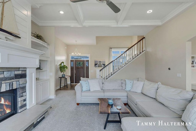 6129 W Bay Ct, Hudsonville, MI 49426 - living area featuring ceiling fan, a stone fireplace, ornamental molding, beam ceiling, and light carpet
