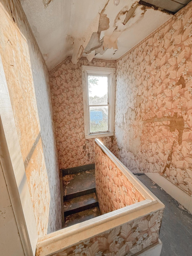 10677 Mason Dr, Grant, MI 49327 - stairs featuring lofted ceiling and wallpapered walls