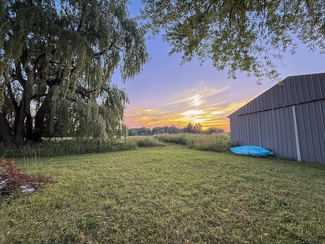 10677 Mason Dr, Grant, MI 49327 - yard at dusk featuring an outbuilding, a yard, and an outdoor structure