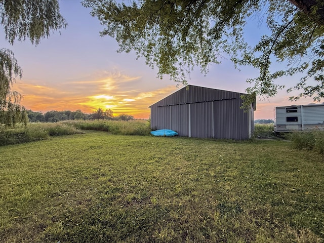 10677 Mason Dr, Grant, MI 49327 - yard at dusk featuring an outbuilding, a yard, and an outdoor structure