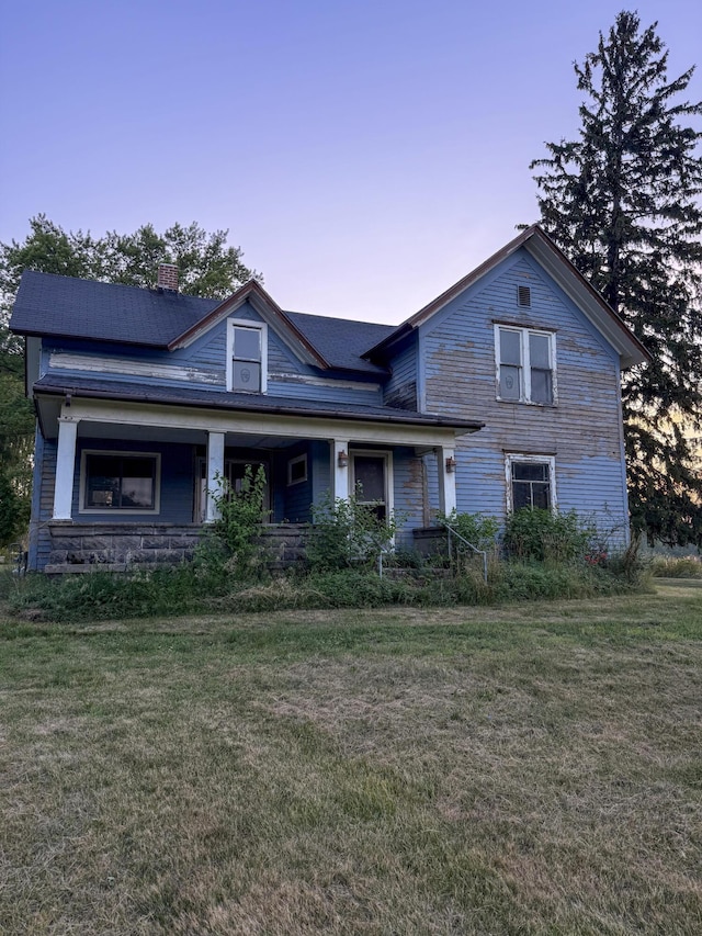 10677 Mason Dr, Grant, MI 49327 - view of front facade with a chimney, a lawn, and a porch