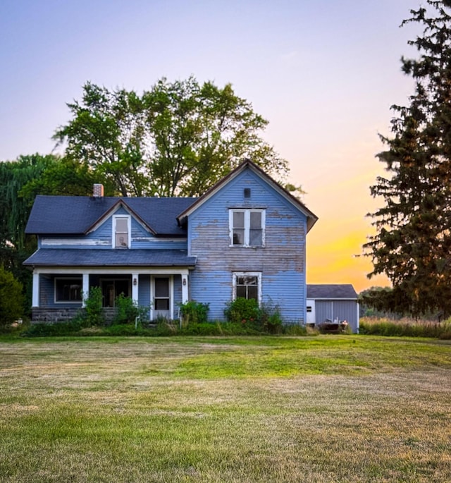 10677 Mason Dr, Grant, MI 49327 - view of front of house featuring a front yard and a chimney