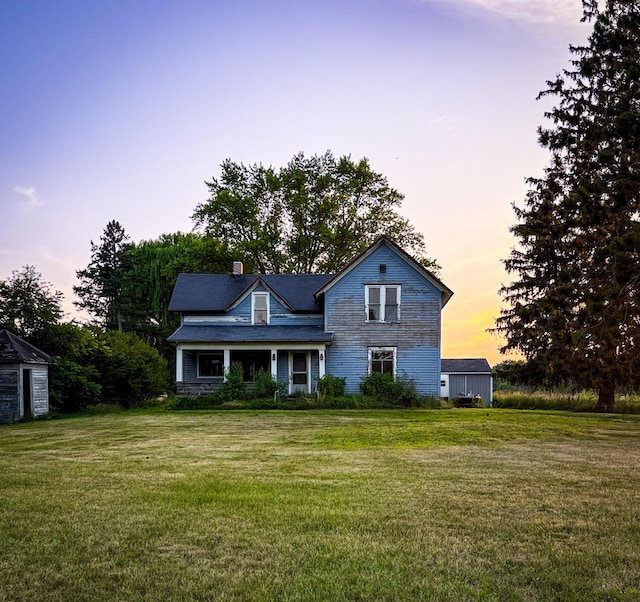 10677 Mason Dr, Grant, MI 49327 - traditional-style house featuring a front lawn and a chimney