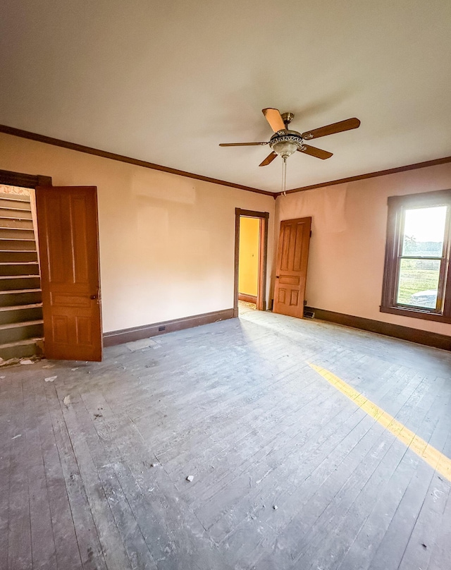 10677 Mason Dr, Grant, MI 49327 - unfurnished room featuring hardwood / wood-style floors, a ceiling fan, ornamental molding, and stairs