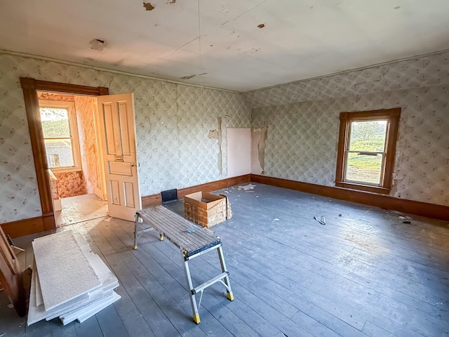 10677 Mason Dr, Grant, MI 49327 - spare room with hardwood / wood-style flooring and wallpapered walls