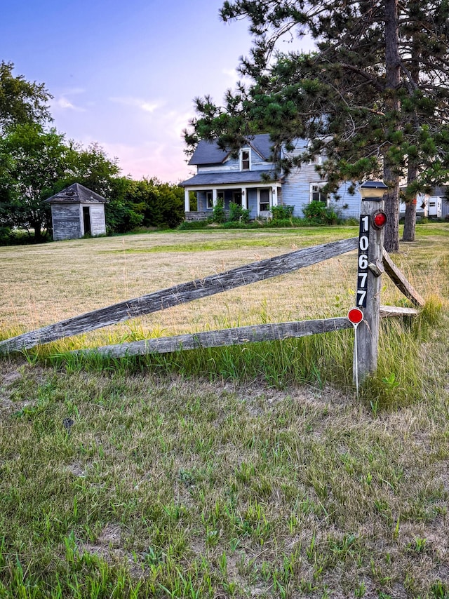 10677 Mason Dr, Grant, MI 49327 - view of grassy yard with a garage