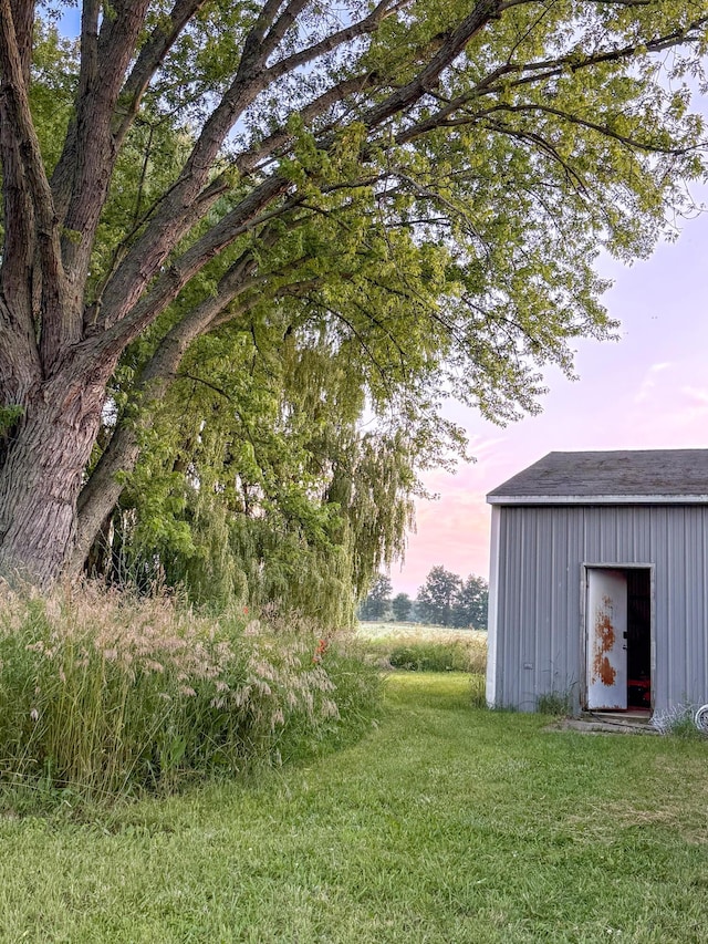 10677 Mason Dr, Grant, MI 49327 - view of green lawn featuring a storage shed