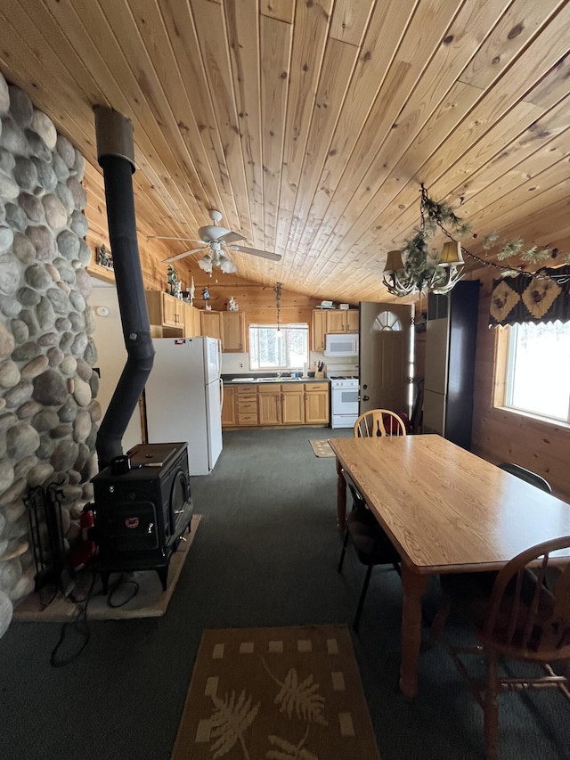 9279 S Forman Rd, Baldwin, MI 49304 - dining room featuring a wood stove, dark colored carpet, healthy amount of natural light, wooden ceiling, and ceiling fan