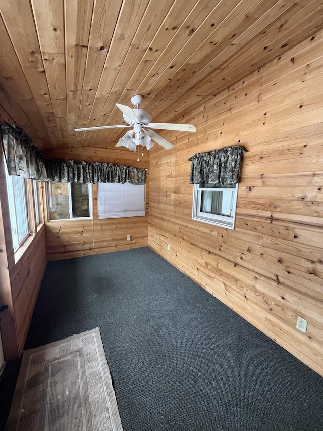 9279 S Forman Rd, Baldwin, MI 49304 - spare room featuring wood walls, carpet floors, wooden ceiling, and a ceiling fan