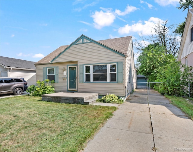 8460 Busko Ave, Utica, MI 48093 - bungalow-style home with a shingled roof and driveway