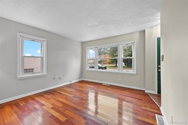 8460 Busko Ave, Utica, MI 48093 - spare room featuring hardwood / wood-style floors and a textured ceiling