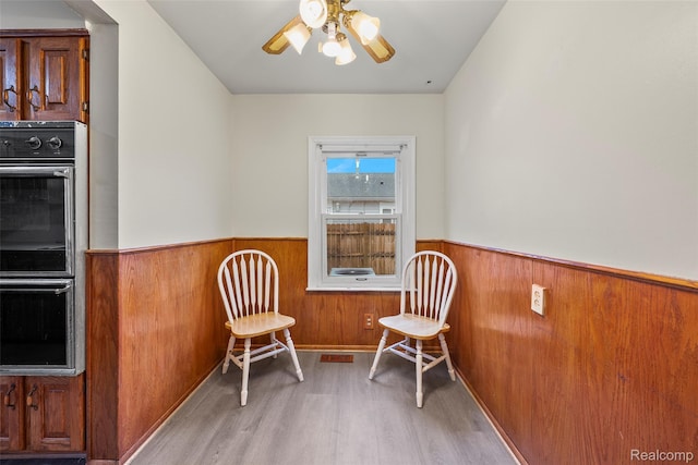 8460 Busko Ave, Utica, MI 48093 - sitting room with a wainscoted wall, wood finished floors, wood walls, and a ceiling fan