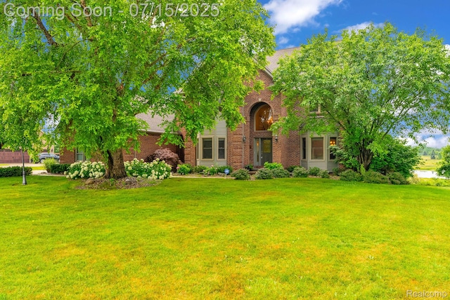 11656 Kings Colony, Grand Blanc, MI 48439 - view of front of home with brick siding and a front lawn