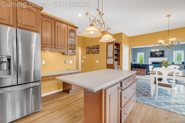 11656 Kings Colony, Grand Blanc, MI 48439 - kitchen with stainless steel fridge with ice dispenser, light wood-style flooring, light countertops, glass insert cabinets, and pendant lighting
