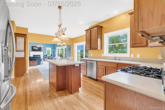 11656 Kings Colony, Grand Blanc, MI 48439 - kitchen featuring stainless steel appliances, light wood-style flooring, a chandelier, light countertops, and a kitchen island