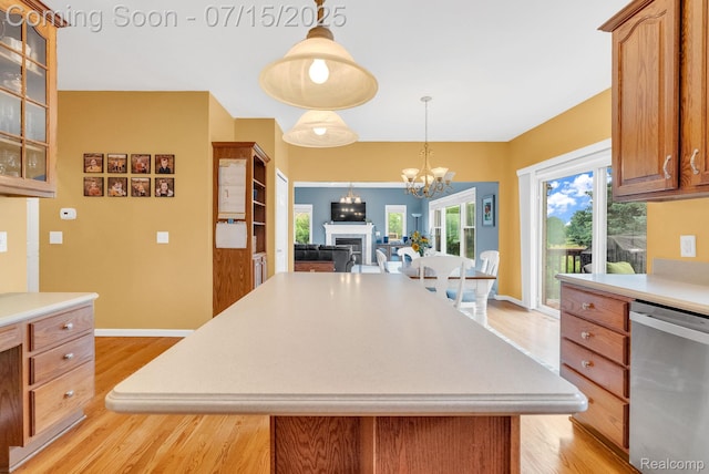 11656 Kings Colony, Grand Blanc, MI 48439 - kitchen with stainless steel dishwasher, light wood-style floors, light countertops, and a chandelier