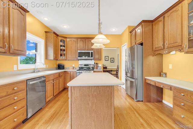 11656 Kings Colony, Grand Blanc, MI 48439 - kitchen featuring appliances with stainless steel finishes, light wood-type flooring, a kitchen island, built in desk, and glass insert cabinets