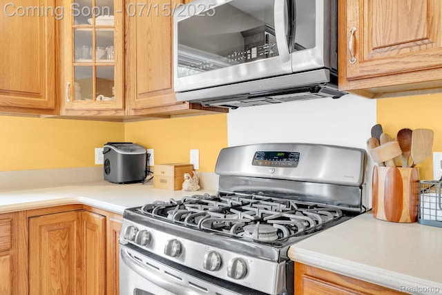 11656 Kings Colony, Grand Blanc, MI 48439 - kitchen with appliances with stainless steel finishes, glass insert cabinets, and light countertops