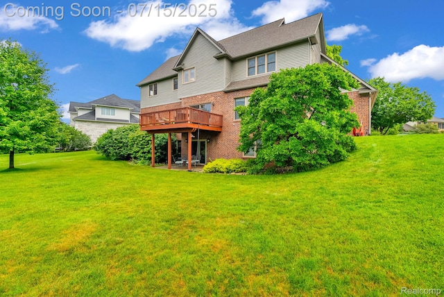 11656 Kings Colony, Grand Blanc, MI 48439 - rear view of property with brick siding, a lawn, and a deck