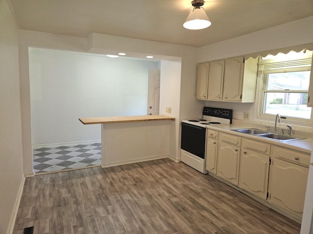 3521 Henderson Rd, Spring Arbor, MI 49283 - kitchen with white electric stove, tile patterned floors, light countertops, a peninsula, and recessed lighting
