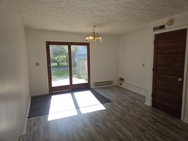 3521 Henderson Rd, Spring Arbor, MI 49283 - spare room featuring a baseboard heating unit, a chandelier, dark wood-type flooring, and a textured ceiling