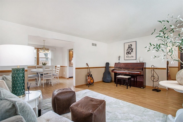 275 W State St, Coldwater, MI 49036 - living room featuring a chandelier and wood finished floors