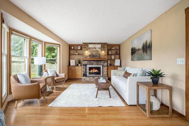 275 W State St, Coldwater, MI 49036 - living area featuring light wood-type flooring, a fireplace, and built in features