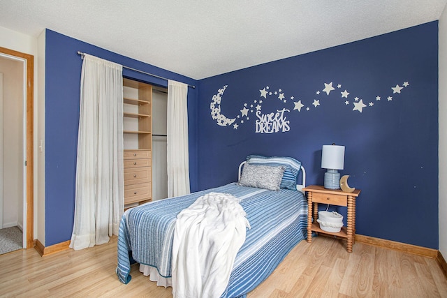 275 W State St, Coldwater, MI 49036 - bedroom featuring wood finished floors, a closet, and a textured ceiling