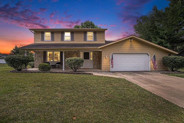 275 W State St, Coldwater, MI 49036 - traditional home with driveway, a front lawn, an attached garage, covered porch, and stone siding