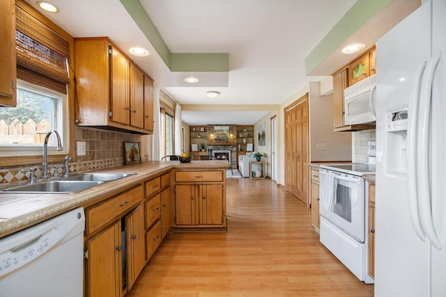 275 W State St, Coldwater, MI 49036 - kitchen featuring white appliances, a fireplace, light wood finished floors, a peninsula, and open floor plan